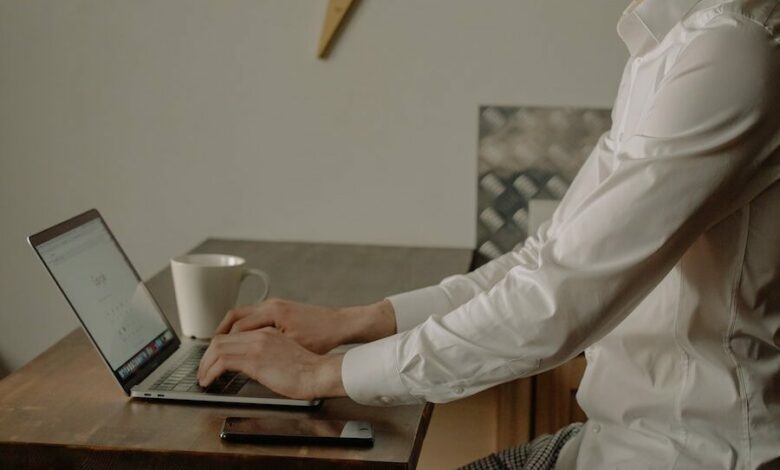 Man in White Dress Shirt Using Black Laptop Computer