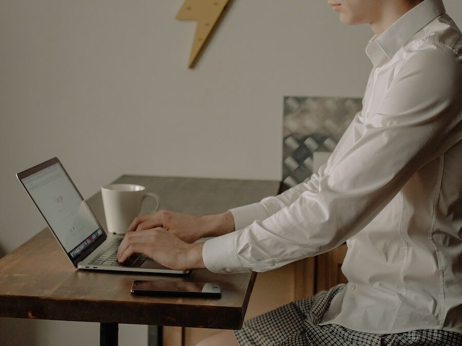 Man in White Dress Shirt Using Black Laptop Computer