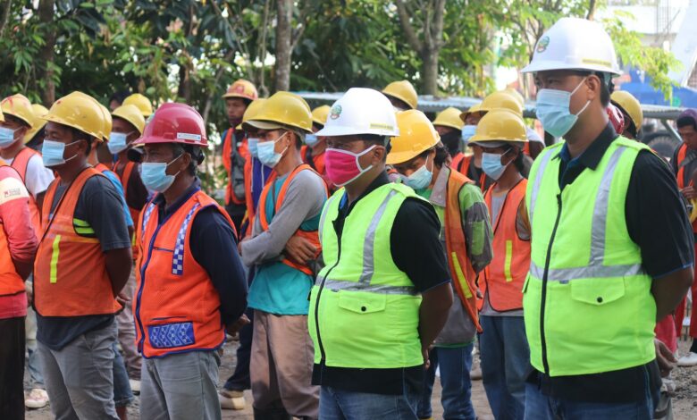 group of people wearing orange hard hat and backpacks