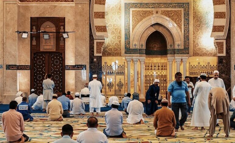 men kneeling and bowing inside building