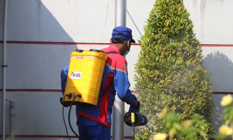 woman in blue and red jacket holding yellow plastic bucket