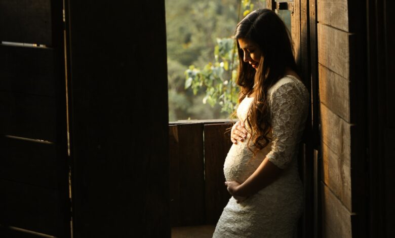 pregnant woman holding her womb