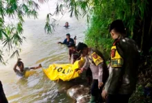 Personel Polsek Sindangbarang dibantu warga mengevakuasi jenazah Apid (64) dari Sungai Cisadea di Kampung Pasalakan, Desa Sirnagalih, Sindangbarang, Cianjur, Kamis (25/12/2025).